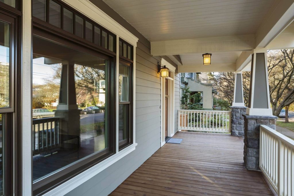 dark brown trim windows with beige siding